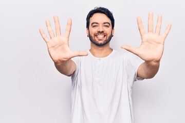 Young hispanic man wearing casual clothes showing and pointing up with fingers number ten while smiling confident and happy.