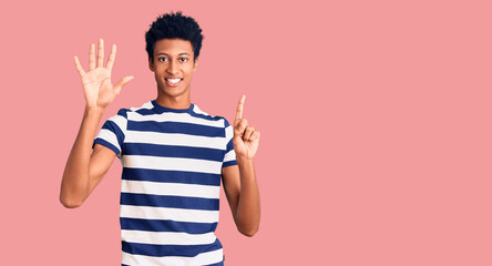 Young african american man wearing casual clothes showing and pointing up with fingers number six while smiling confident and happy.