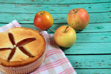 curd apple pudding and apples on napkin on blue wooden background flat lay
