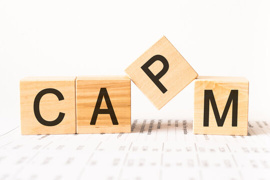 Word capm. Wooden small cubes with letters isolated on white background with copy space available.Business Concept image.