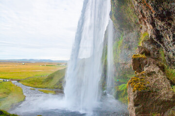 Seljalandsfoss - Seljalandsfoss is located in the South Region in Iceland right by Route 1. One of the interesting things about this waterfall is that visitors can walk behind it into a small cave. 