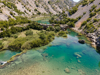 Obraz na płótnie Canvas Zrmanja River in northern Dalmatia, Croatia is famous for its crystal clear waters and countless waterfalls surrounded by a deep canyon.