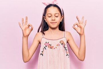 Beautiful child girl wearing casual clothes relax and smiling with eyes closed doing meditation gesture with fingers. yoga concept.