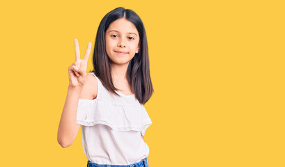 Beautiful child girl wearing casual clothes showing and pointing up with fingers number two while smiling confident and happy.