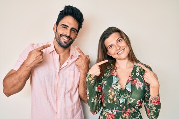 Beautiful young couple of boyfriend and girlfriend together smiling cheerful showing and pointing with fingers teeth and mouth. dental health concept.