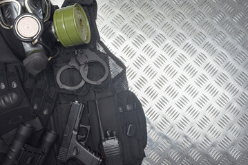 An airsoft equipment on the metal background with copy space.