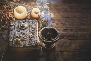 A magic book and potion on the witch doctor table close up.
