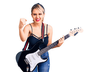 Fototapeta premium Young beautiful blonde woman playing electric guitar annoyed and frustrated shouting with anger, yelling crazy with anger and hand raised