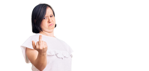 Brunette woman with down syndrome wearing casual white tshirt showing middle finger, impolite and rude fuck off expression