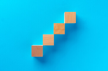 Top view of wooden toy blocks on blue