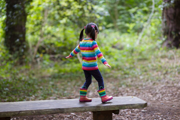 young girl playing in the summer forest park