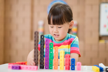  young girl play number blocks for homeschooling