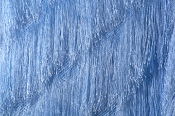 Horizontal blue background from fabric with a long thread, the effect of fur.