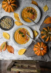 Obraz na płótnie Canvas Creamy pumpkin soup topped with pumpkin seeds close-up 