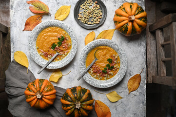 Obraz na płótnie Canvas Creamy pumpkin soup topped with pumpkin seeds close-up 
