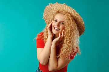 Beautiful blonde woman model posing in a straw hat