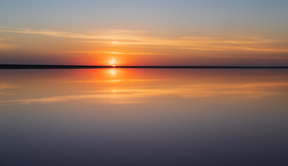 Sunset on the Genichesk pink extremely salty lake (colored by microalgae with crystalline salt depositions), Ukraine.