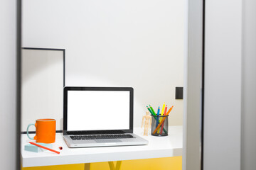 Laptop and colorful pencils at home office desk mockup.