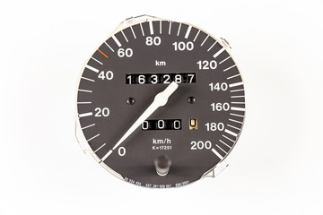 an analog car speedometer with built-in odometers isolated on a white background