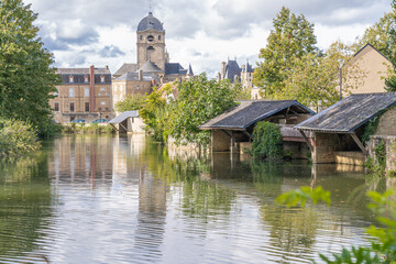 Alençon, France - 10 04 2020: Reflections of the Notre-Dame d'Alençon Basilica on the river - obrazy, fototapety, plakaty
