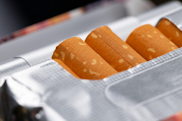 Open new pack of cigarettes close up