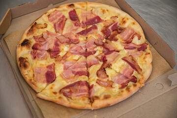 Pizza with cheese and ham in an Italian pizzeria

