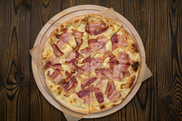 Pizza with cheese and ham in an Italian pizzeria
