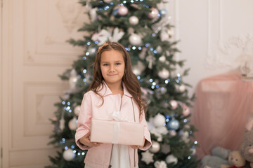 Happy childhood, magical Christmas tale. Little princess with Santa's present for Christmas