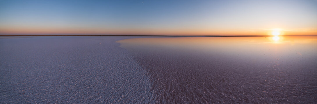 Sunset on the Genichesk pink extremely salty lake (colored by microalgae with crystalline salt depositions), Ukraine.