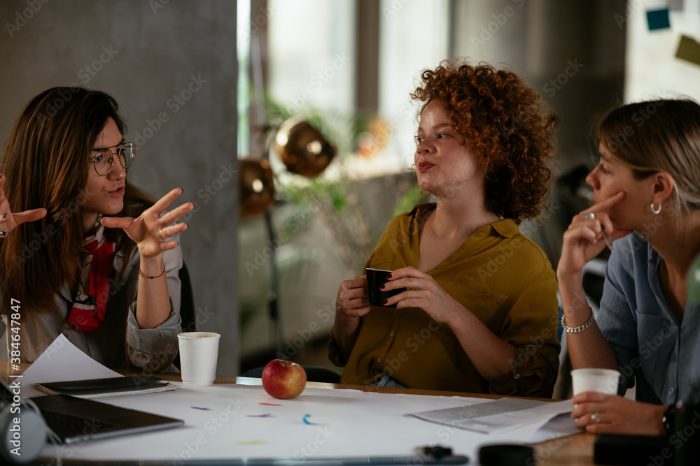 Canvas Prints Businesswomen drinking coffee in office.. Colleagues discussing work in office.