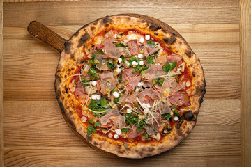 pizza with sausage, cheese, tomatoes and herbs
