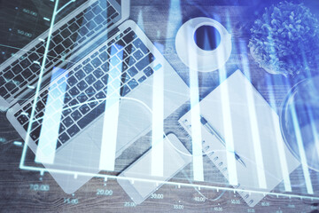Financial market graph and top view computer on the desktop background. Double exposure. Investment concept.