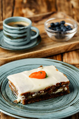 Slice of carrot cake on green plate