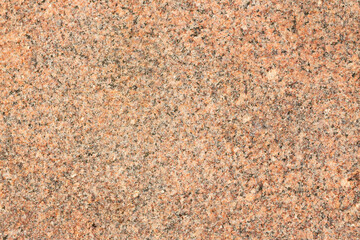 Granite texture. Natural granite with a grainy pattern. Stone background. Solid rough surface of rock. Durable construction and decoration material. Close-up.