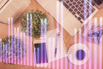Multi exposure of financial chart hologram over desktop with phone. Top view. Mobile trade platform...