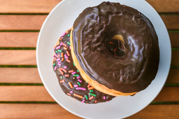 Chocolate Donuts piled up on a table flat layout image