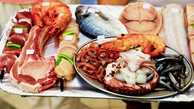 Symi, Greece: Raw Sea food such as octopus, Salmon, Squid and Prawn etc freshly caught from mediterranean sea put on display for selling in one of the island commercial market