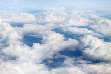 Naklejka na ściany i meble Fabulous, white clouds and blue sky. View from the airplane window.