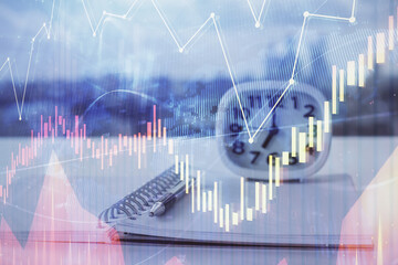 Multi exposure of financial graph drawings and desk with open notebook background. Concept of forex
