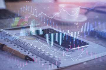 Double exposure of forex chart drawing and cell phone background. Concept of financial data analysis