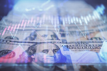 Double exposure of forex graph drawing over us dollars bill background. Concept of financial...