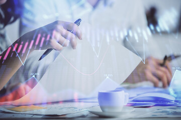 Double exposure of forex graph drawing over people taking notes background. Concept of financial analysis