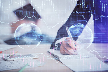 Double exposure of forex chart drawing over people taking notes background. Concept of financial analysis