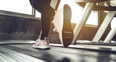 Fototapeta na wymiar Female athlete legs walking treadmill machine, Sport activity, cardio exercise, active lifestyle, sunlight