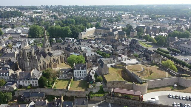 General view of French town of Guingamp in summer looking out over medieval Basilica and walls of ancient fortified chateau, Brittany