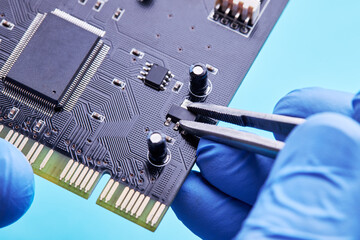 computer hardware support service concept. technician diagnosing and repairing pcb circuit board
