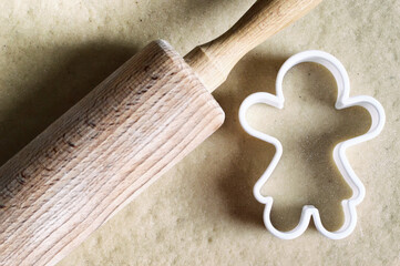 Gingerbread girl cookie cutter and gingerbread dough. Christmas baking concept