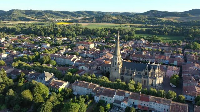 View from drone of houses of Mirepoix town and cathedral of St-Maurice at sunny summer day, France