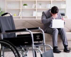 Dsabled businessman on wheelchair working home