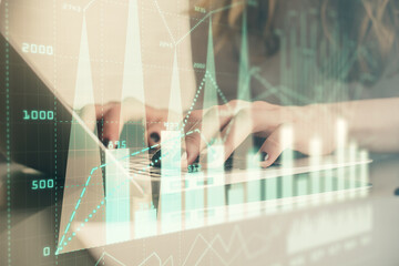 Double exposure of woman hands typing on computer and forex chart hologram drawing. Stock market invest concept.